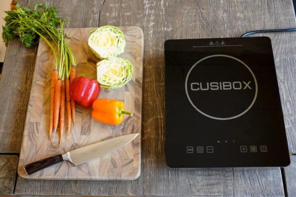 Tobox Induction Cooktop on table with chopped veggies next to it